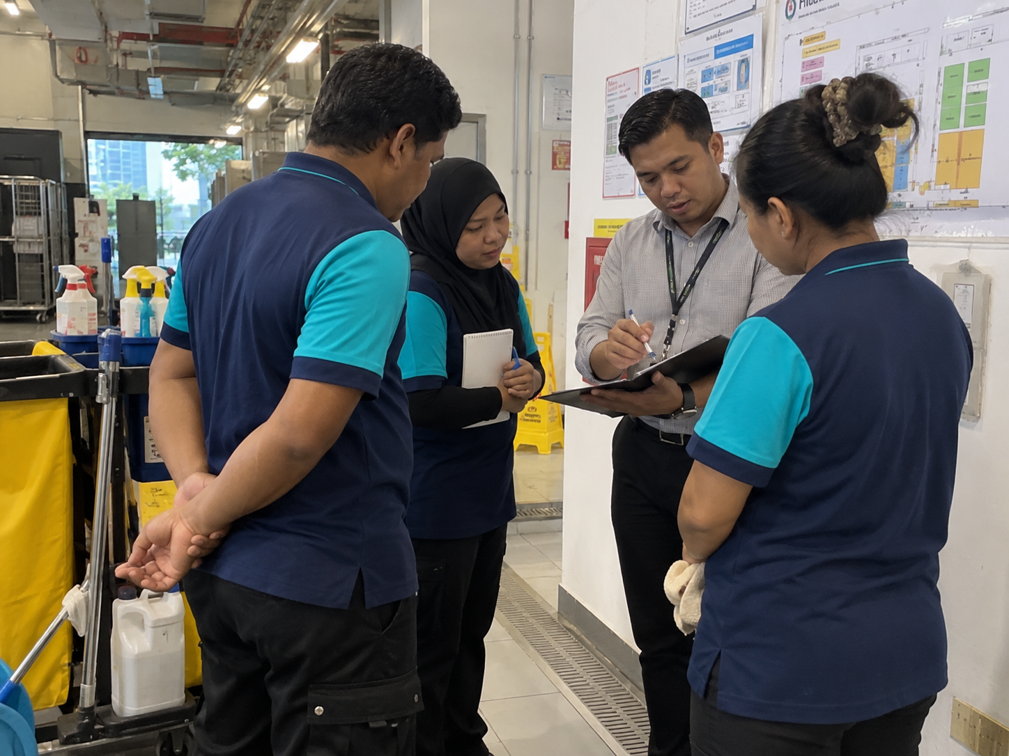 Cleaning supervisor discussing site requirements and plans for commercial and industrial cleaning services in KL